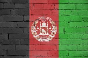 Afghanistan flag is painted onto an old brick wall photo