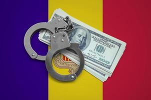 Andorra flag  with handcuffs and a bundle of dollars. Currency corruption in the country. Financial crimes photo