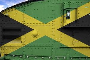 Jamaica flag depicted on side part of military armored tank closeup. Army forces conceptual background photo