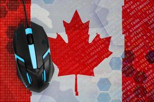 Canada flag  and computer mouse. Digital threat, illegal actions on the Internet photo