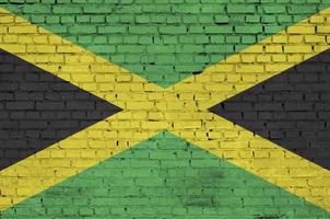 Jamaica flag is painted onto an old brick wall photo