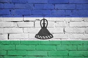 Lesotho flag is painted onto an old brick wall photo