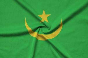 Mauritania flag  is depicted on a sports cloth fabric with many folds. Sport team banner photo