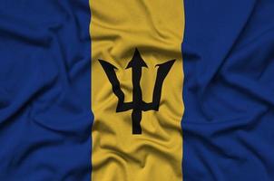 Barbados flag  is depicted on a sports cloth fabric with many folds. Sport team banner photo