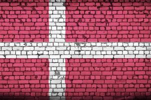 Denmark flag is painted onto an old brick wall photo