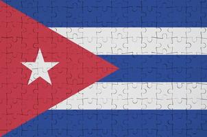 Cuba flag  is depicted on a folded puzzle photo