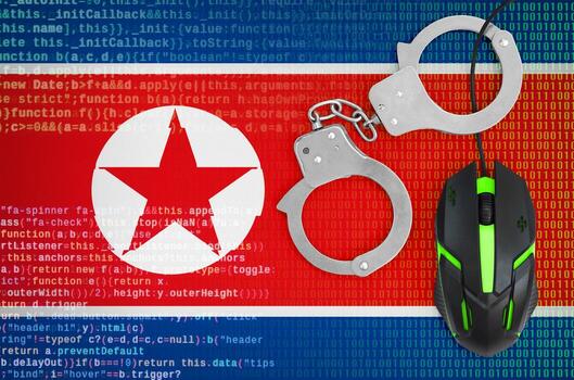 North Korea flag  and handcuffed computer mouse. Combating computer crime, hackers and piracy photo