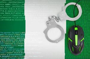 Nigeria flag  and handcuffed computer mouse. Combating computer crime, hackers and piracy photo