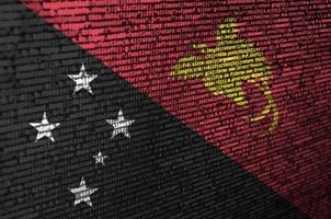 Papua New Guinea flag  is depicted on the screen with the program code. The concept of modern technology and site development photo