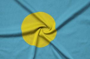 Palau flag  is depicted on a sports cloth fabric with many folds. Sport team banner photo