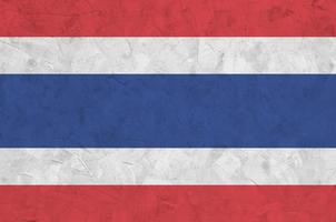 Thailand flag depicted in bright paint colors on old relief plastering wall. Textured banner on rough background photo