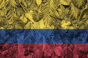 Colombia flag depicted on many leafs of monstera palm trees. Trendy fashionable backdrop photo