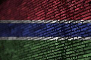 Gambia flag  is depicted on the screen with the program code. The concept of modern technology and site development photo