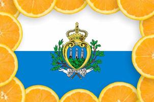 San Marino flag  in fresh citrus fruit slices frame photo