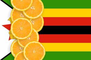 Zimbabwe flag and citrus fruit slices vertical row photo