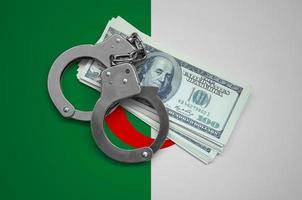 Algeria flag  with handcuffs and a bundle of dollars. Currency corruption in the country. Financial crimes photo