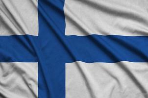 Finland flag  is depicted on a sports cloth fabric with many folds. Sport team banner photo