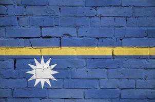 Nauru flag is painted onto an old brick wall photo