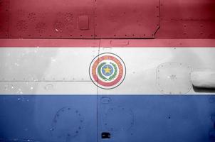 Paraguay flag depicted on side part of military armored helicopter closeup. Army forces aircraft conceptual background photo