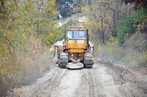 Quarry aggregate with heavy duty machinery. Caterpillar loader Excavator with backhoe driving to construction site quarry photo