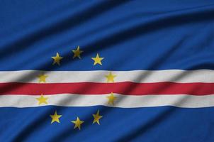 Cabo verde flag  is depicted on a sports cloth fabric with many folds. Sport team banner photo