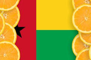 Guinea Bissau flag  in citrus fruit slices vertical frame photo