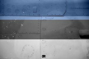 Estonia flag depicted on side part of military armored helicopter closeup. Army forces aircraft conceptual background photo