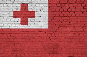 Tonga flag is painted onto an old brick wall photo