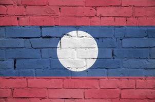 Laos flag is painted onto an old brick wall photo