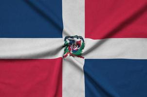 Dominican Republic flag  is depicted on a sports cloth fabric with many folds. Sport team banner photo