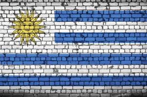 Uruguay flag is painted onto an old brick wall photo