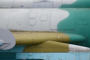 Dirty detailed texture of old fighter aircraft body painted in camouflage with many rivets photo