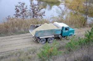 Dump truck transports sand and other minerals in the mining quarry. Heavy industry photo