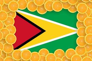 Guyana flag  in fresh citrus fruit slices frame photo