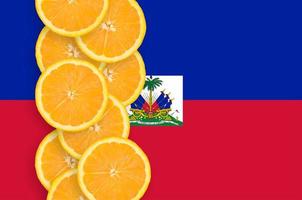 Haiti flag and citrus fruit slices vertical row photo