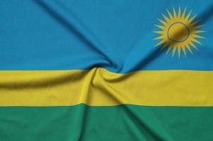 Rwanda flag  is depicted on a sports cloth fabric with many folds. Sport team banner photo