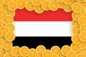 Yemen flag  in fresh citrus fruit slices frame photo