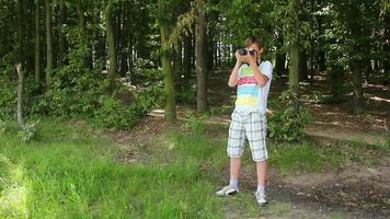 Boy takes photograph with analogic camera video