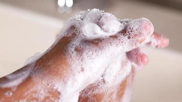 Thoroughly washing hands with rich lather at bathroom sink video