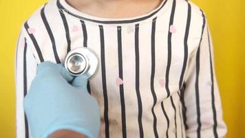 A doctor listens to a child's heart video