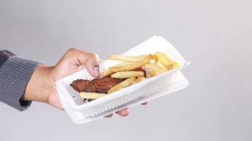 Fried chicken and fries in a plastic plate video