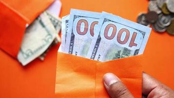 Money bills in an orange envelope video