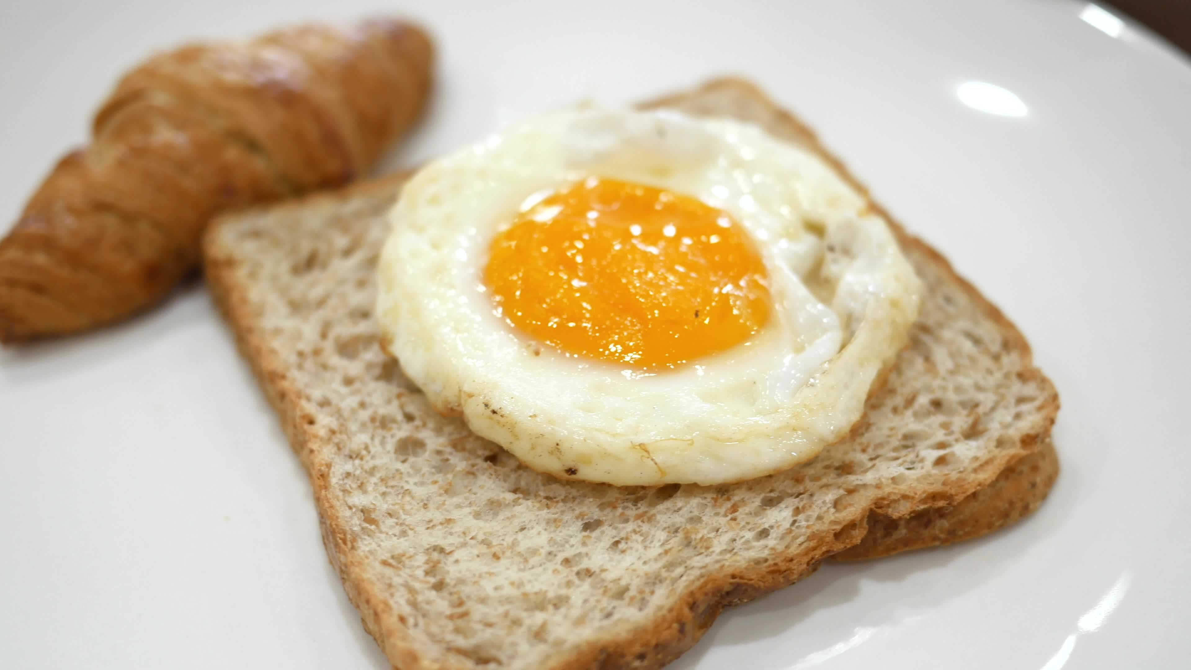 Egg over easy on a toast 14193576 Stock Video at Vecteezy