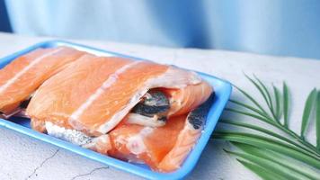 Salmon filet in blue foam container on table video