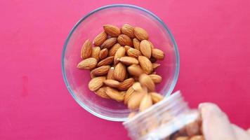 Almonds poured into glass bowl video