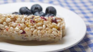 A plate with cereal bars and blueberries close up video