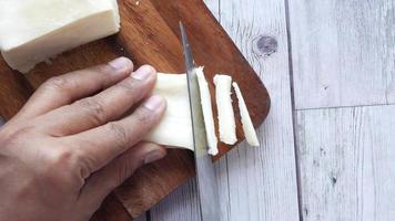 Cuting slices of mozzarella cheese video