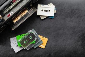 Top view retro radio and colorful cassette tape on black floor with copy space photo