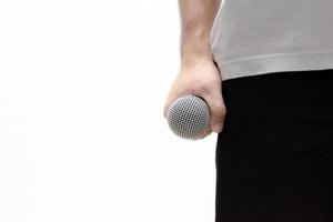 Man with microphone on white background photo