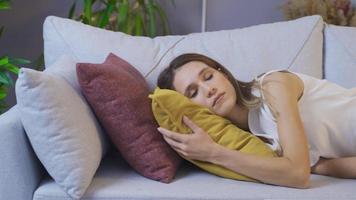 The woman lying on the sofa is asleep. Young woman lays on the sofa and falls asleep. video